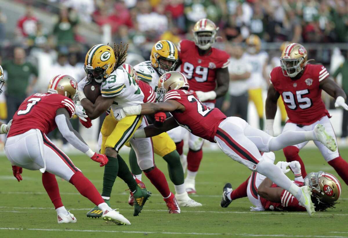 K’Waun Williams (24) goes for the tackle on Aaron Jones (33) in the first half as the San Francisco 49ers played the Greenbay Packers at Levi’s Stadium in Santa Clara, Calif., on Sunday, September 26, 2021.