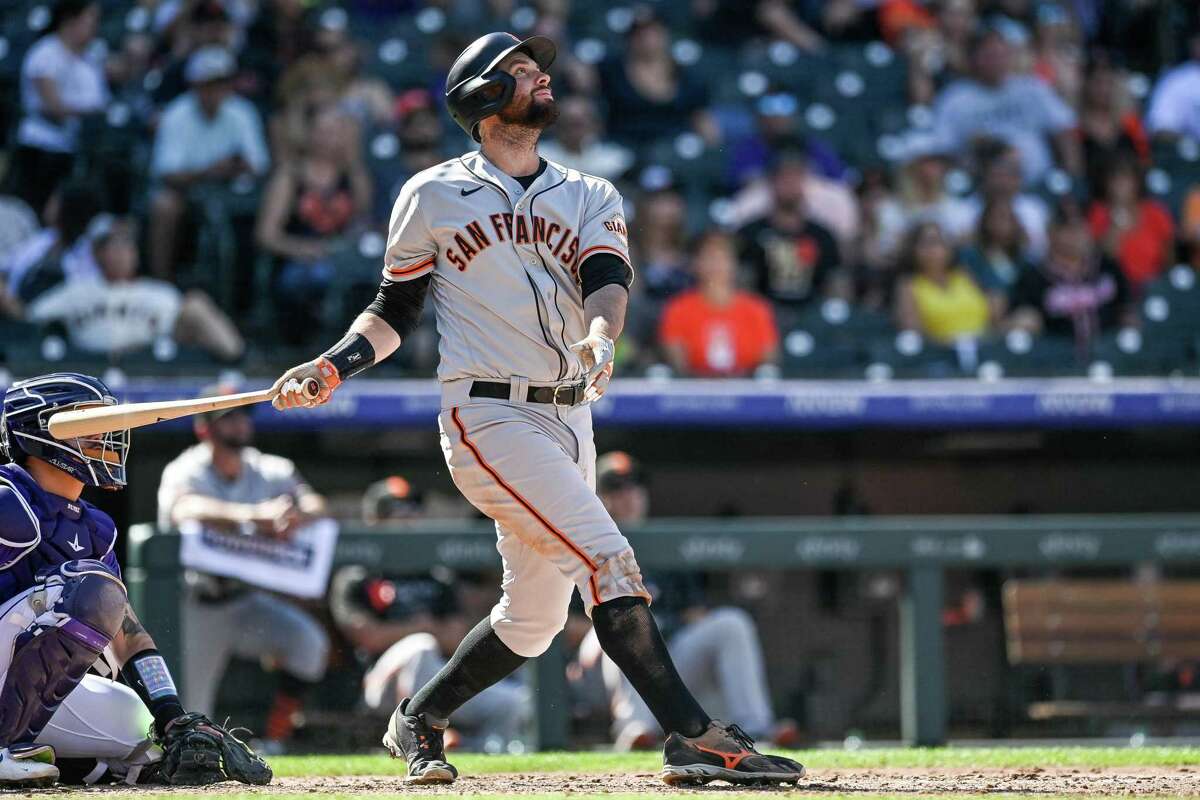 DENVER, CO - SEPTEMBER 26: Brandon Belt #9 of the San Francisco Giants hits a fifth inning double against the Colorado Rockies at Coors Field on September 26, 2021 in Denver, Colorado. (Photo by Dustin Bradford/Getty Images)