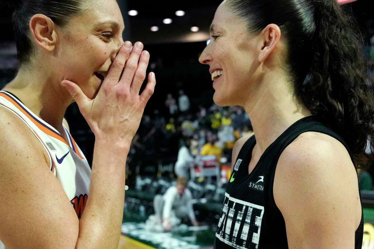 Phoenix Mercury's Diana Taurasi, left, talks with Seattle Storm's Sue Bird after the Mercury defeated the Storm in the second round of the WNBA basketball playoffs Sunday, Sept. 26, 2021, in Everett, Wash. (AP Photo/Elaine Thompson)