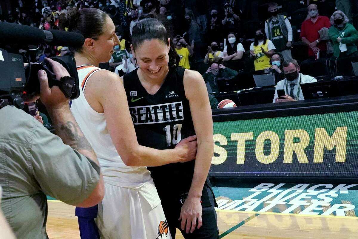 Seattle Storm's Sue Bird, right, is greeted by Phoenix Mercury's Diana Taurasi after their second round WNBA basketball playoff game Sunday, Sept. 26, 2021, in Everett, Wash. Phoenix won in overtime 85-80. (AP Photo/Elaine Thompson)
