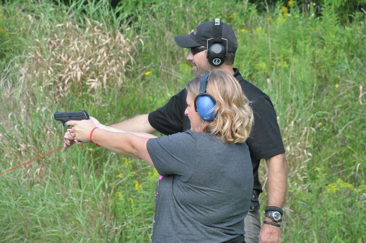 Kevin Brown of Randy's Hunting Center offers advice to a woman participating in a 'Ladies Night' shooting event at Thumb Sportsman's Club gun range in Bad Axe. Randy's and the club are hosting another event on Wednesday. Sept. 29, at 5:30 p.m., with an optional safety lesson starting at 5 p.m. (Courtesy Photo)