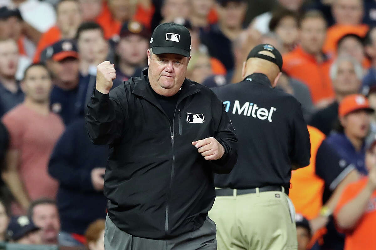 Umpire Joe West calls out the Astros' Jose Altuve on fan interference in the first inning of Game 4 of the American League Championship Series against the Boston Red Sox on October 17, 2018 at Minute Maid Park.