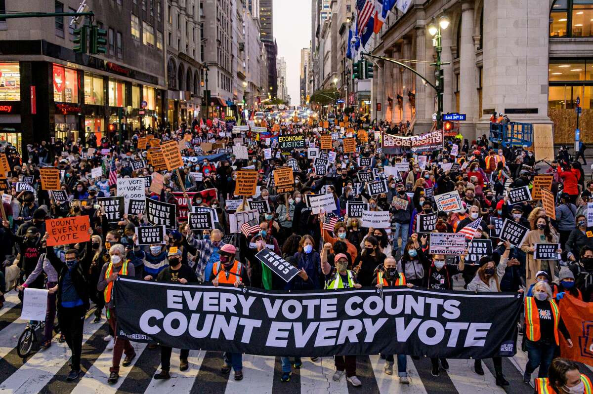 Pictured is Manhattan, New York. Participants holding a banner reading: "EVERY VOTE COUNTS/COUNT EVERY VOTE" at a protest in 2020.