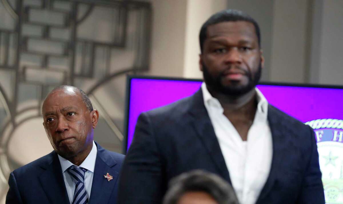 Mayor Sylvester Turner stands behind Curtis “50 Cent” Jackson, who along with his G-Unity Foundation, announced a program to equip students from three Houston ISD high schools with critical skills at City Hall’s Legacy Room, Monday, May 17, 2021, in Houston.