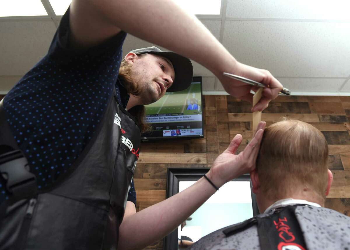 Matt Conklin cuts the hair of Andrew Anziano of Orange at Matt's Barber Shop on the Boston Post Road in Orange on September 22, 2021.