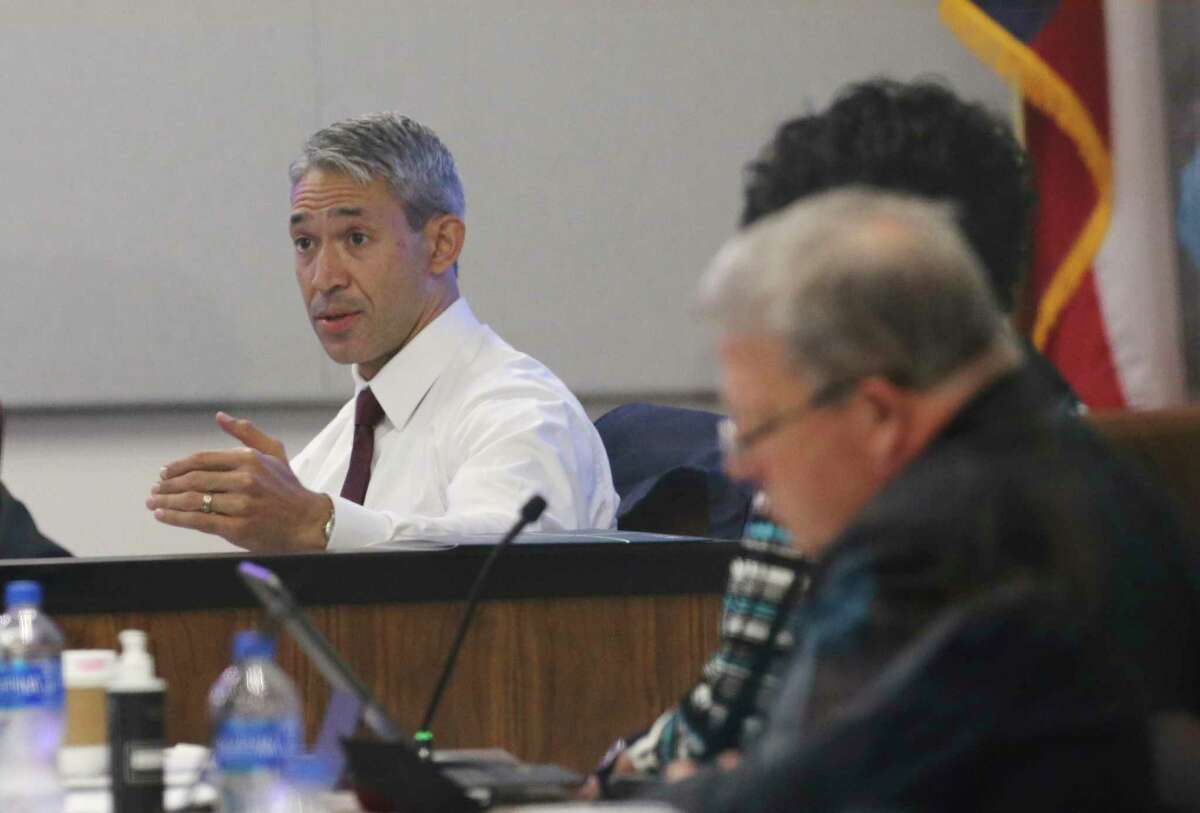 Mayor Ron Nirenberg (center) speaks as CPS Energy officials meet for the utility's monthly board meeting where a possible rate hike was discussed on Monday, Sept. 27, 2021. A small group of residents objecting to the increase voiced their issues outside of the CPS Energy headquarters before the meeting.