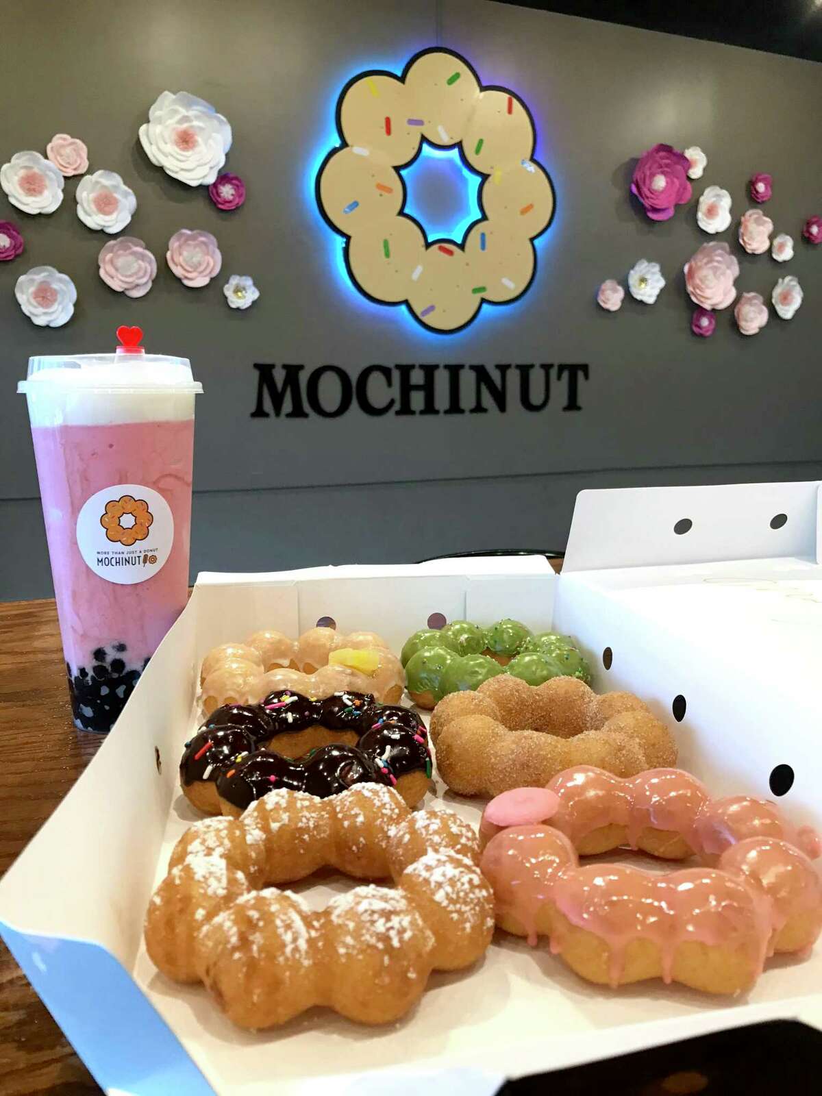 A selection of doughnuts and a strawberry cheese smoothie from Mochinut