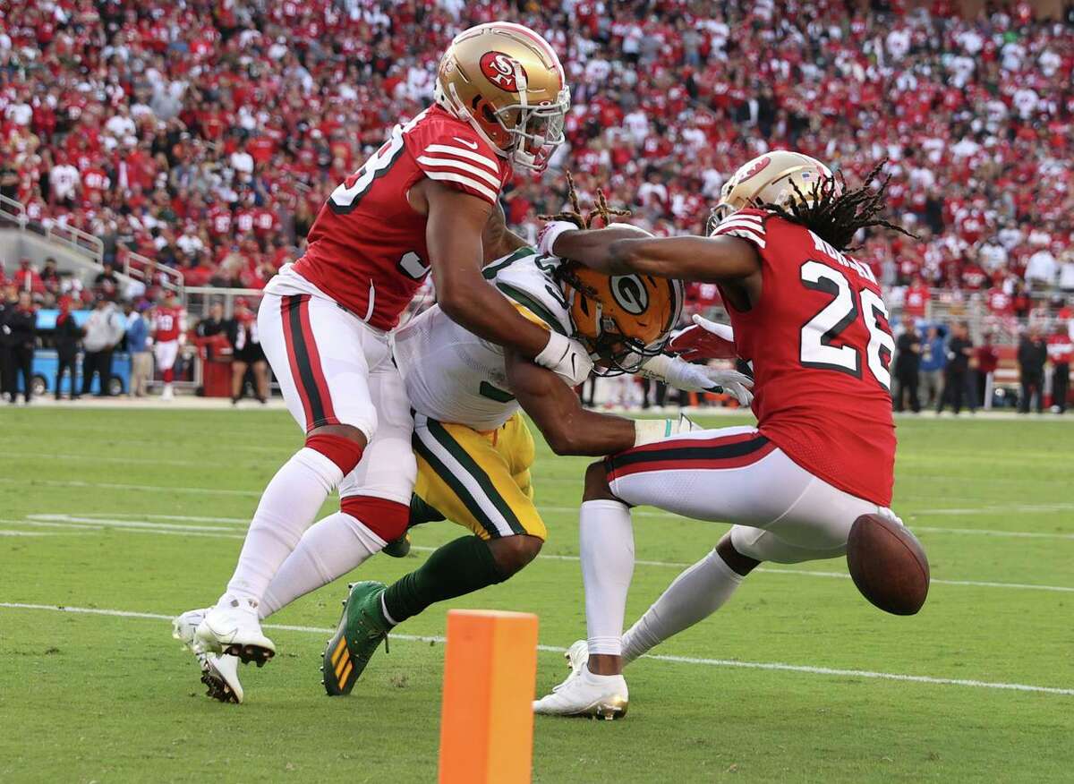 Niners Josh Norman and Deommodore Lenoir force Aaron Jones into a fumble that went out of bounds during the second quarter of Sunday’s loss to Green Bay.