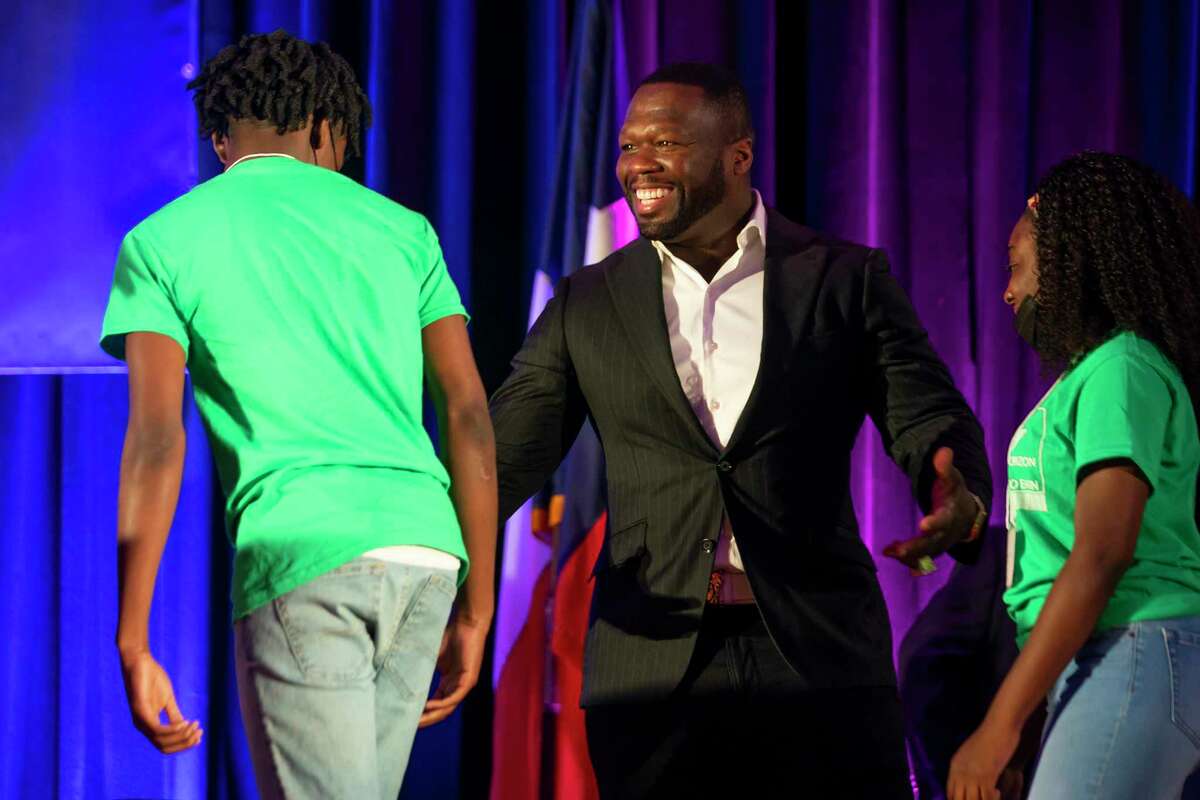 Curtis "50 Cent" Jackson greets high school students from Worthing High School during the induction ceremony for the G-Unity Business Lab, Monday, Sept. 27, 2021, at Wheatley High School in Houston. The initiative is a partnership between Curtis "50 Cent" Jackson's G-Unity Foundation and Houston Independent School District. The business lab will offer MBA-style business classes for students interested in entrepreneurial endeavors.