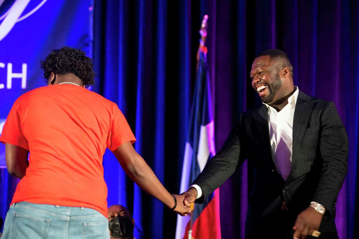 Curtis "50 Cent" Jackson laughs as he greets a student from Kashmere High School during the induction ceremony for the G-Unity Business Lab, Monday, Sept. 27, 2021, at Wheatley High School in Houston. The initiative is a partnership between Curtis "50 Cent" Jackson's G-Unity Foundation and Houston Independent School District. The business lab will offer MBA-style business classes for students interested in entrepreneurial endeavors.