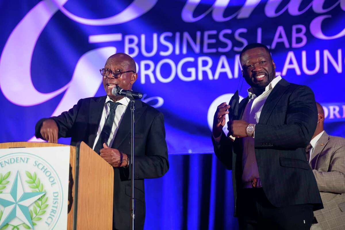 Houston Mayor Sylvester Turner laughs with Curtis "50 Cent" Jackson as he speaks during the induction ceremony for the G-Unity Business Lab, Monday, Sept. 27, 2021, at Wheatley High School in Houston. The initiative is a partnership between Curtis "50 Cent" Jackson's G-Unity Foundation and Houston Independent School District. The business lab will offer MBA-style business classes for students interested in entrepreneurial endeavors.