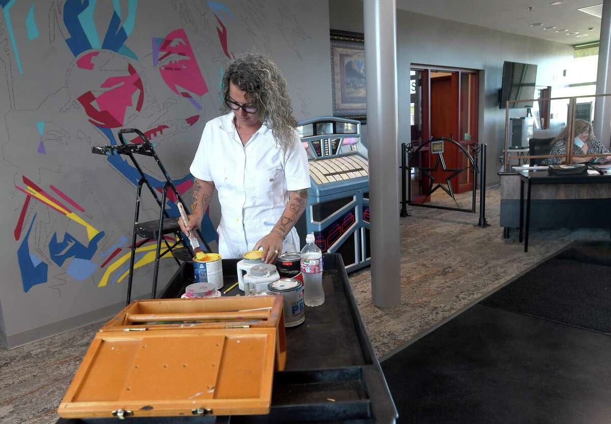 Artist Kimberly Brown starts work on a wall-length Janis Joplin mural at the Ben J. Rogers Regional Visitors Center Wednesday. The piece will fill the space next to the jukebox, where a display was destroyed during flooding from Imelda. Center Director Kathi Hughes said they chose to feature Janis Joplin not only because she is part of the rich musical history of Southeast Texas, but because "people are fascinated by Janis. So many people, especially international travelers, want to know about her" and where she grew up. Joplin and Spindletop are among the top tourist draws, Hughes said. The public is invited to watch Brown's work in progress as it continues Thursday. Photo made Wednesday, September 22, 2021 Kim Brent/The Enterprise