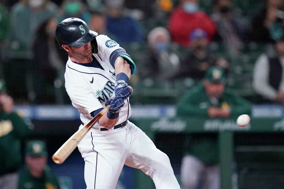 Seattle Mariners' Mitch Haniger hits a three-run home run against the Oakland Athletics in the fourth inning of a baseball game Monday, Sept. 27, 2021, in Seattle. (AP Photo/Elaine Thompson)