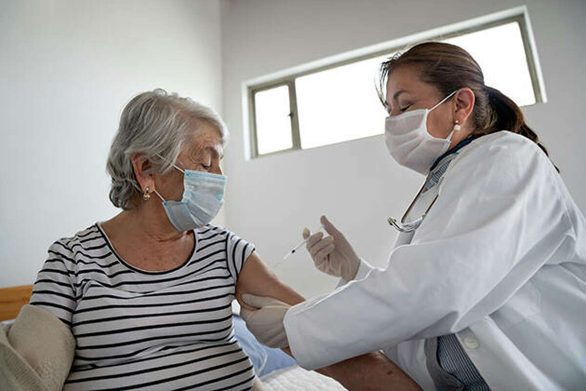 A file photo of a medical professional administering a vaccine to a patient.