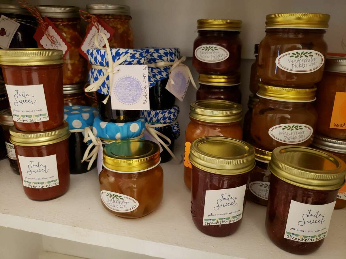 Julia Currie’s pantry shelf in Easton is a colorful mix of jars, large and small, labeled or tagged, some dressed for giving with bright cloth caps.