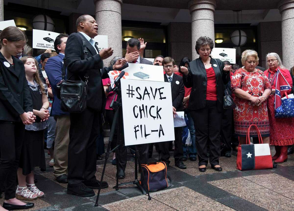 Pastor Stephen Broden of the Fair Park Bible Fellowship Church in Dallas, Texas leads a prayer to end a press conference for Save Chick-fil-A Day for religious freedom in the central court outdoor rotunda at the Texas State Capitol. [Dimitri Staszewski/San Antonio Express-News]