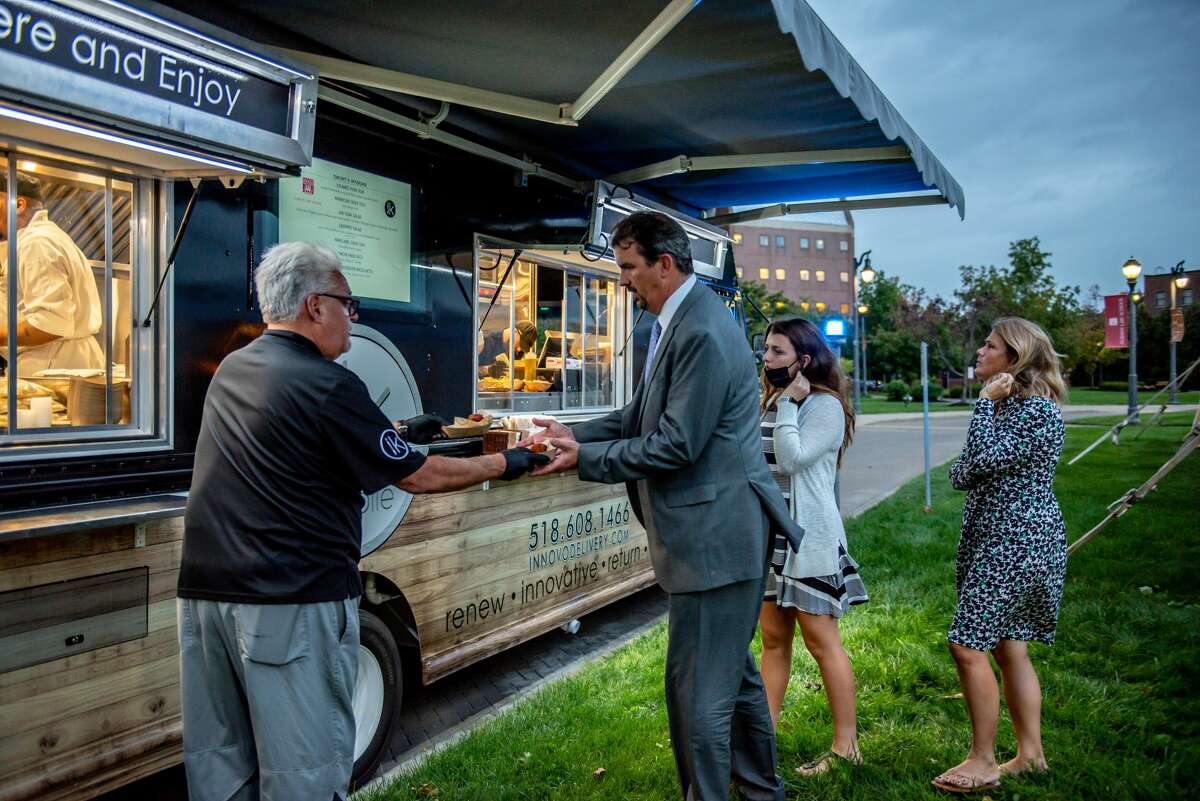 John LaPosta, chef-owner of Innovo Kitchen in Latham, greets and serves guests at a September event served by Innovo's food truck at Albany Law School in Albany.