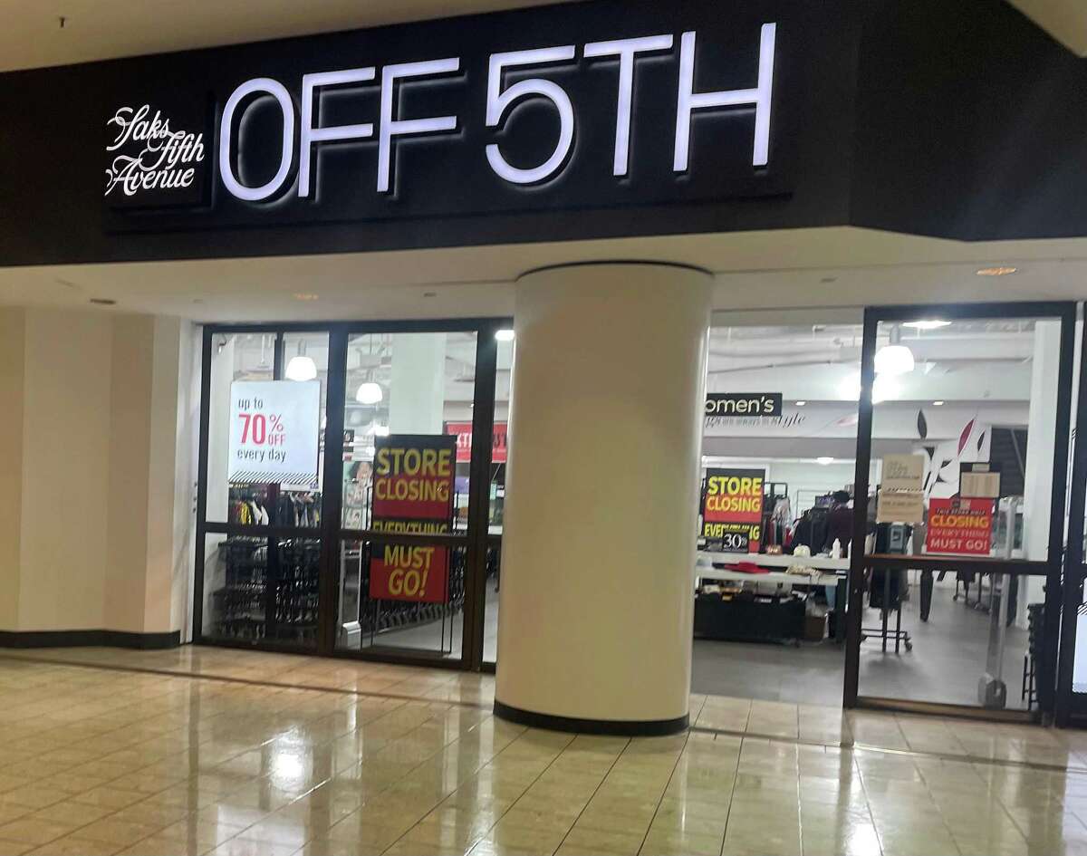 Signs inside the Saks Off 5th department store at Stamford Town Center mall announce the store’s upcoming closing.