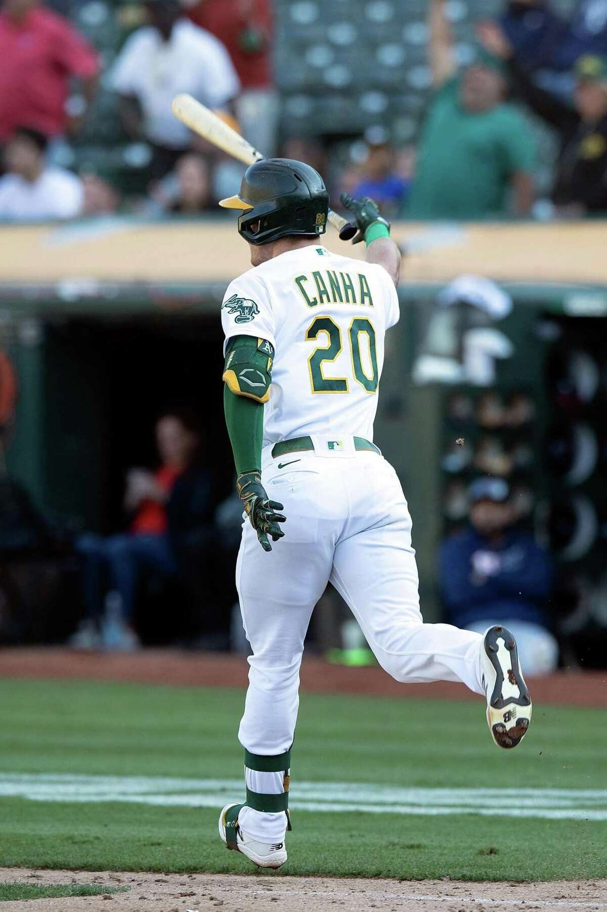 OAKLAND, CALIFORNIA - SEPTEMBER 26: Mark Canha #20 of the Oakland Athletics flips his bat after hitting a walk-off single against the Houston Astros in the ninth inning at RingCentral Coliseum on September 26, 2021 in Oakland, California. The Athletics won 4-3. (Photo by Jason O. Watson/Getty Images)