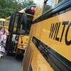 Cider Mill Students head to their buses after the first day of school on Aug. 30, 2021, in Wilton, Conn. A school bus shortage is causing a problem for sports teams throughout the state.
