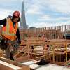 TransAmerica Pyramid peeks out behind wooden walls as workers continue construction on two affordable housing developments, one for seniors and one for multi-family use, along the Embarcadero near Broadway in San Francisco, Calif. Tuesday, February 4, 2020. San Francisco Mayor London Breed is planning to spearhead a signature-gathering effort to put a measure on the November 2020 ballot that will make 100% affordable housing developments easier to build. This measure would also confer streamlining benefits to market-rate housing projects that exceed their affordability requirements.