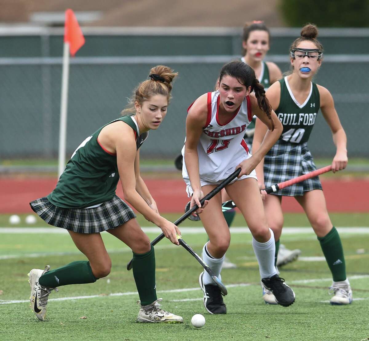 Guilford’s Ella Clarke, left, and Cheshire’s Lauren Houle fight for the ball in the SCC Division A field hockey championship at Cheshire High in 2020.