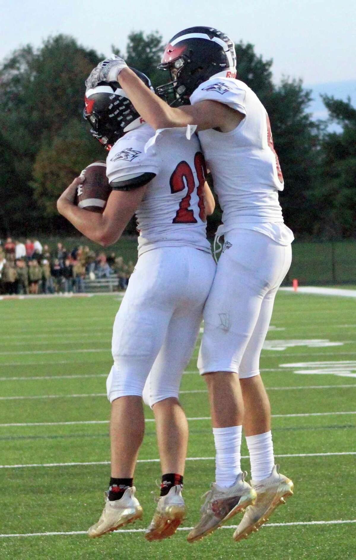 Reed City sophomore Zach Erickson (left) celebrates with junior Seth Jackson in the end zone after scoring a touchdown during Friday night's football game at Cardinal Stadium in Big Rapids. (Herald Review photo/Joe Judd)