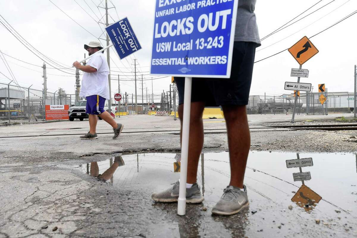 Locked out United Steel Workers Union members, including (from left) Zachary Simon and Carlos Soto, take their shifts picketing outside Beaumont's ExxonMobil plant on Labor Day. Photo made Monday, September 6, 2021 Kim Brent/The Enterprise