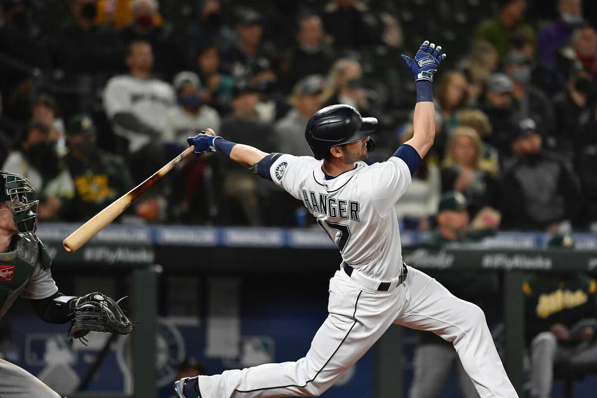 SEATTLE, WASHINGTON - SEPTEMBER 28: Mitch Haniger #17 of the Seattle Mariners hits a solo home run during the seventh inning against the Oakland Athletics at T-Mobile Park on September 28, 2021 in Seattle, Washington. The Mariners won 4-2. (Photo by Alika Jenner/Getty Images)