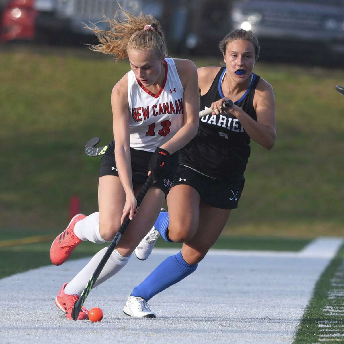 New Canaan’s Zoey Bennett (13) brings the ball up the sideline during the Rams’ field hockey game against Darien at Dunning Field on Oct. 19, 2020.