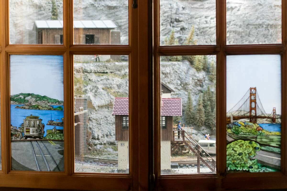 A miniature train set is on display in front of the back windows of the Matterhorn restaurant in San Francisco on September 28, 2021.