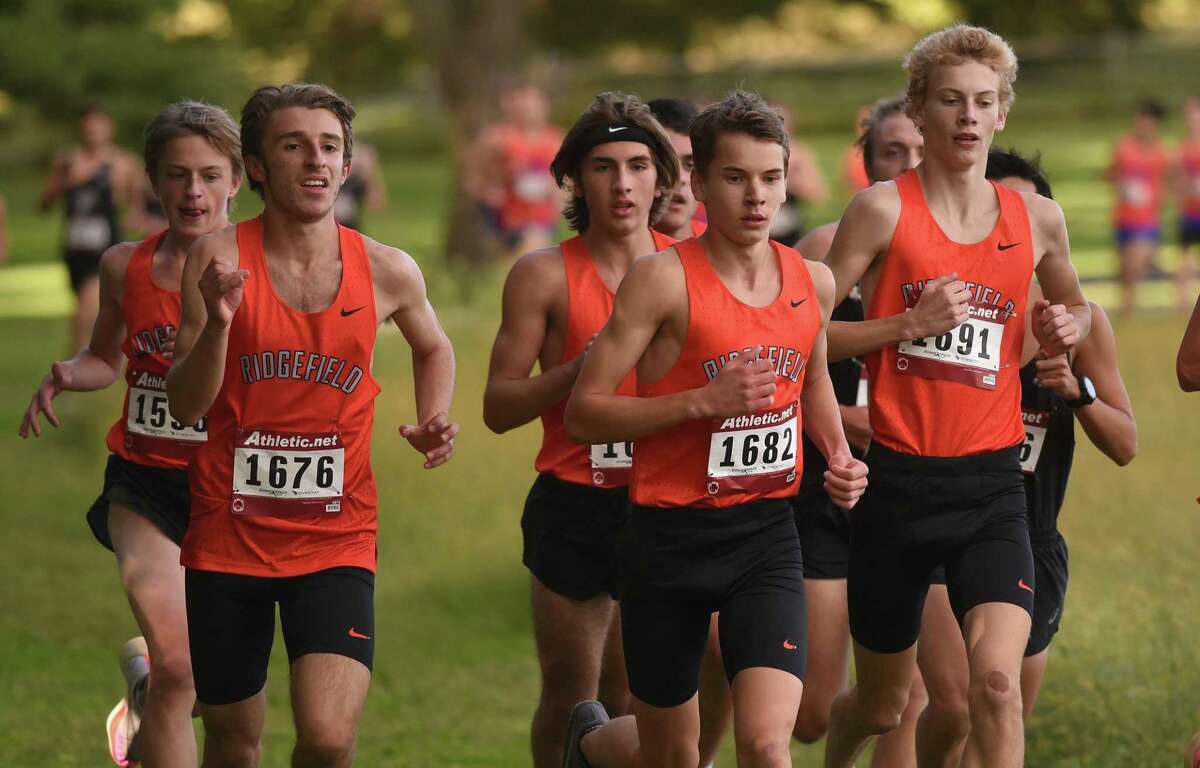 The Ridgefield Tigers run in a pack during a boys cross country meet in New Canaan's Waveny Park on Wednesday, Sept. 29, 2021.
