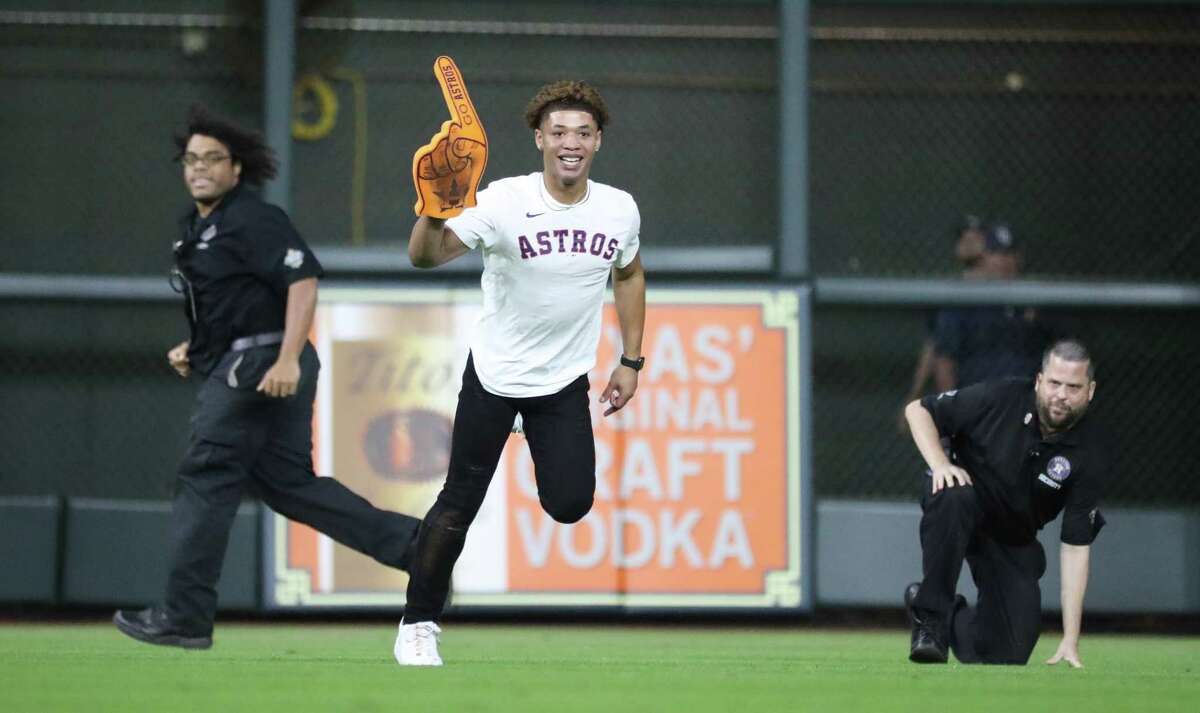 One of two trespassers run on the field during the ninth inning of an MLB baseball game at Minute Maid Park, Wednesday, September 29, 2021, in Houston.