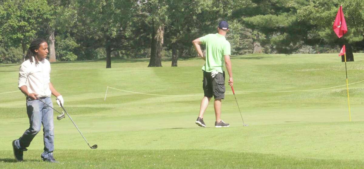 In this file photo, golfers stay busy at the Marquette Trails Golf Course. The Baldwin Rotary Club will be hosting its annual golf outing the year at Marquette Trails Golf Course. (Star file photo)