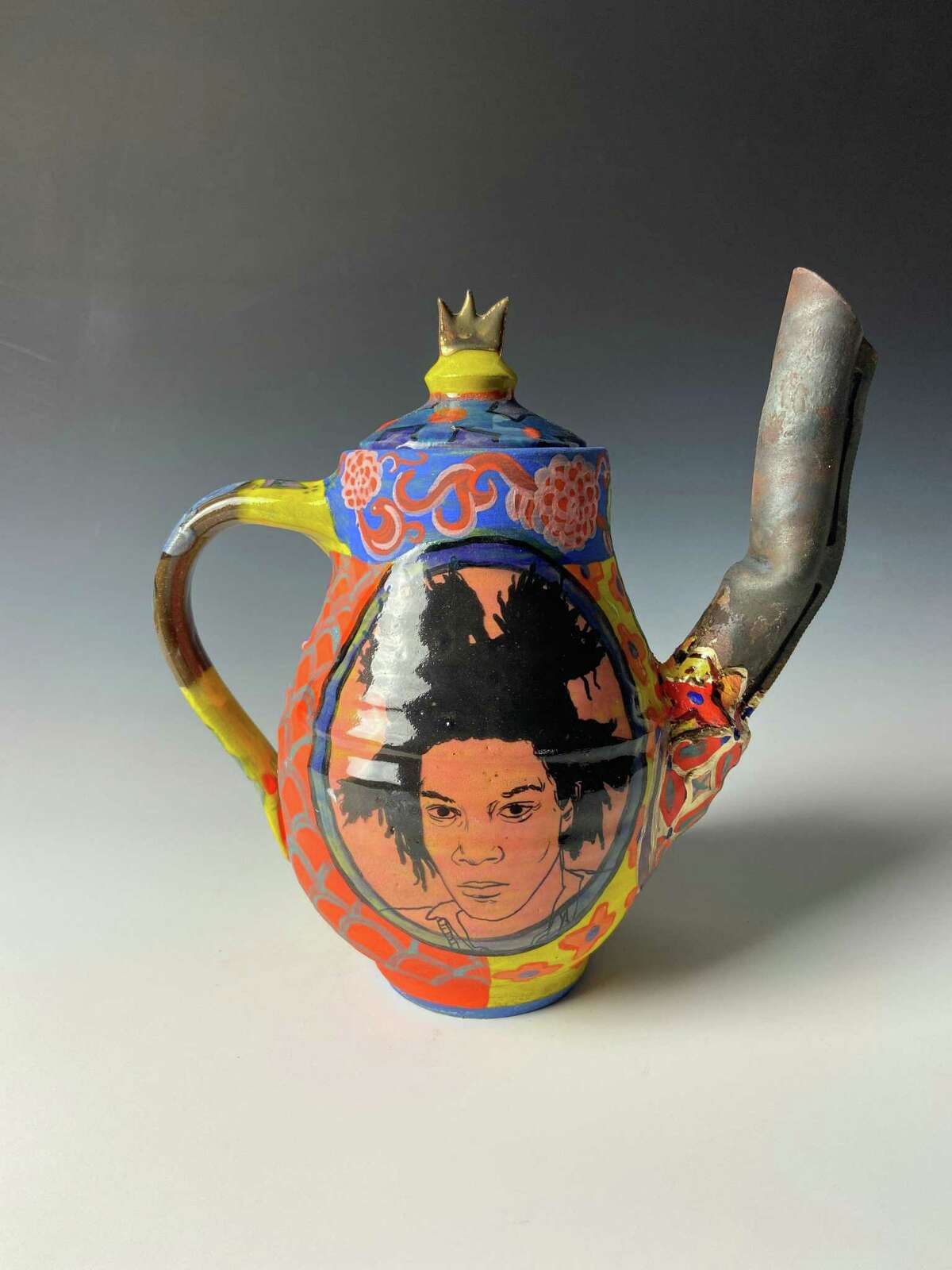 The Fairfield University Art Museum, FUAM, is presenting three displays as part of its fall exhibition series. The exhibitions are: “Carrie Mae Weems: The Usual Suspects,” “Roberto Lugo: New Ceramics,” and “Robert Gerhardt: Mic Check.” The series opened on Saturday, Sept. 18, and is on view through Saturday, Dec. 18. “Roberto Lugo Gun Teapot: Ida B. Wells and Jean-Michel Basquiat, 2021, glazed ceramic, luster, steel, epoxy, enamel,” is shown.