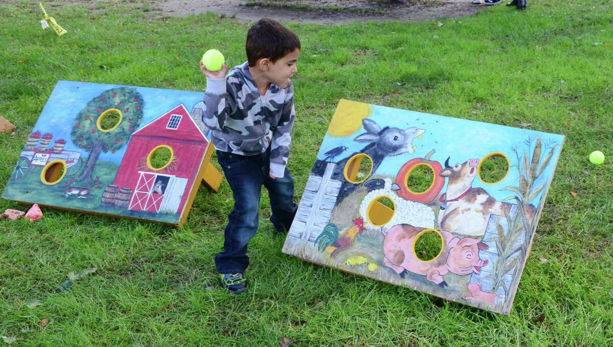 Dominic Trombetta, 3, from New Milford plays a game during New Milford's inaugural Riverfest celebration on Oct. 13, 2018 at Young's Field.