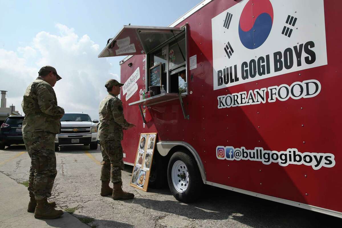 Soldiers queued to buy lunch Thursday in a Korean Bull Gogi Boys food truck on Valley Hi Drive outside of the San Antonio-Lackland Joint Base.  A government shutdown would mean no paychecks for more than 75,800 military and civilian workers here.