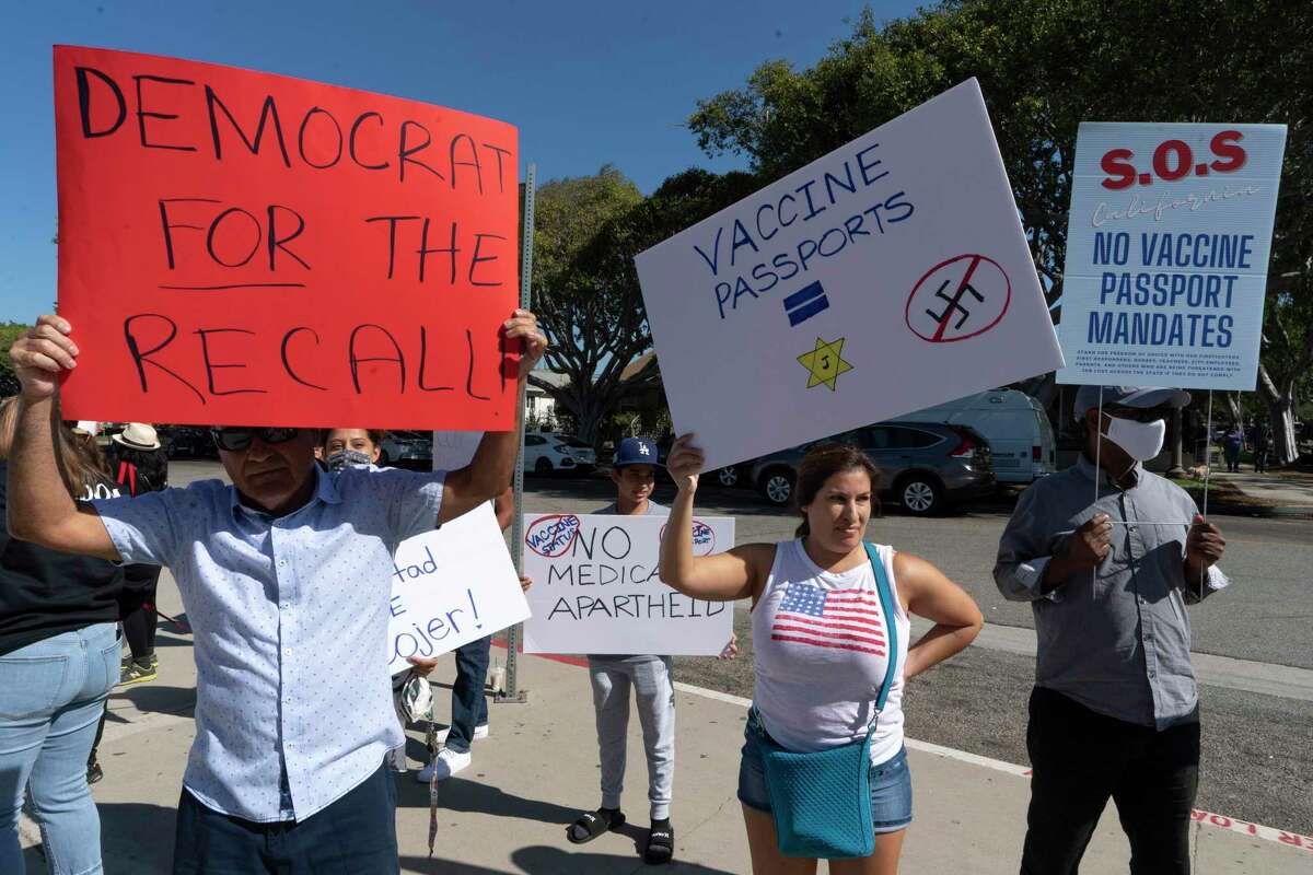 Supporters of the California recall are joined by anti-vaccine protesters before the start of a rally with Gov. Gavin Newsom in Culver City in early September. Support for the recall is closely correlated with low vaccination rates in California counties.