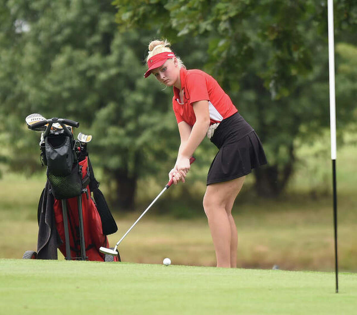 Alton’s Olivia Boyd Paulin watches her putt roll towards the hole on No. 7 at Oak Brook Golf Club during the Edwardsville Regional on Thursday.