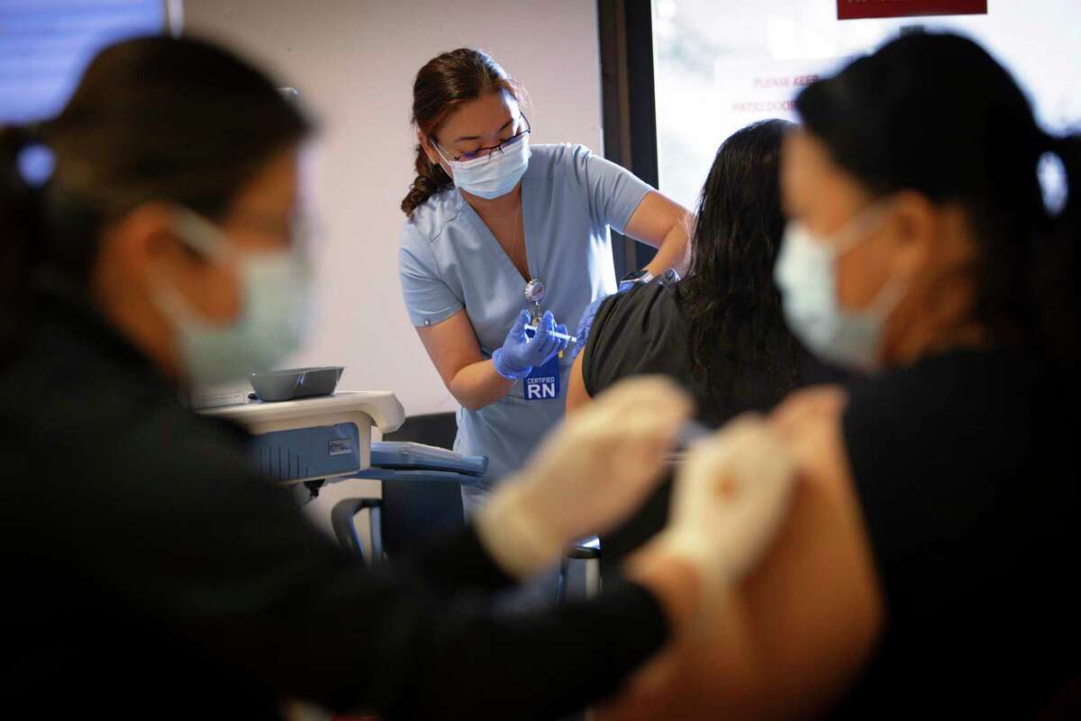Santa Clara Valley Medical Center health care workers receive their COVID vaccine booster shots on Thursday. As vaccination rates edge up and boosters top off immunity, hopes are rising for an end to the pandemic roller coaster ride.