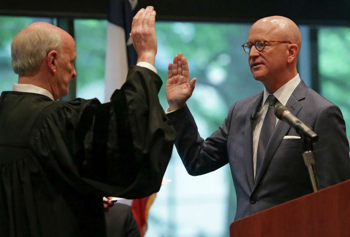 Robert Pitman is sworn in as a federal judge by Chief U.S. District Judge Fred Biery during an investiture ceremony at the Briscoe Western Art Museum on April 16, 2015.