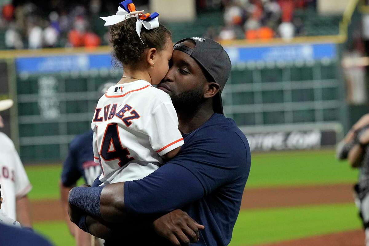 Houston Astros' Yordan Alvarez, right, gets a kiss from his daughter, Mia, after a baseball game against the Tampa Bay Rays Thursday, Sept. 30, 2021, in Houston. The Astros beat the Rays 3-2 to clinch the American League West Division. (AP Photo/David J. Phillip)