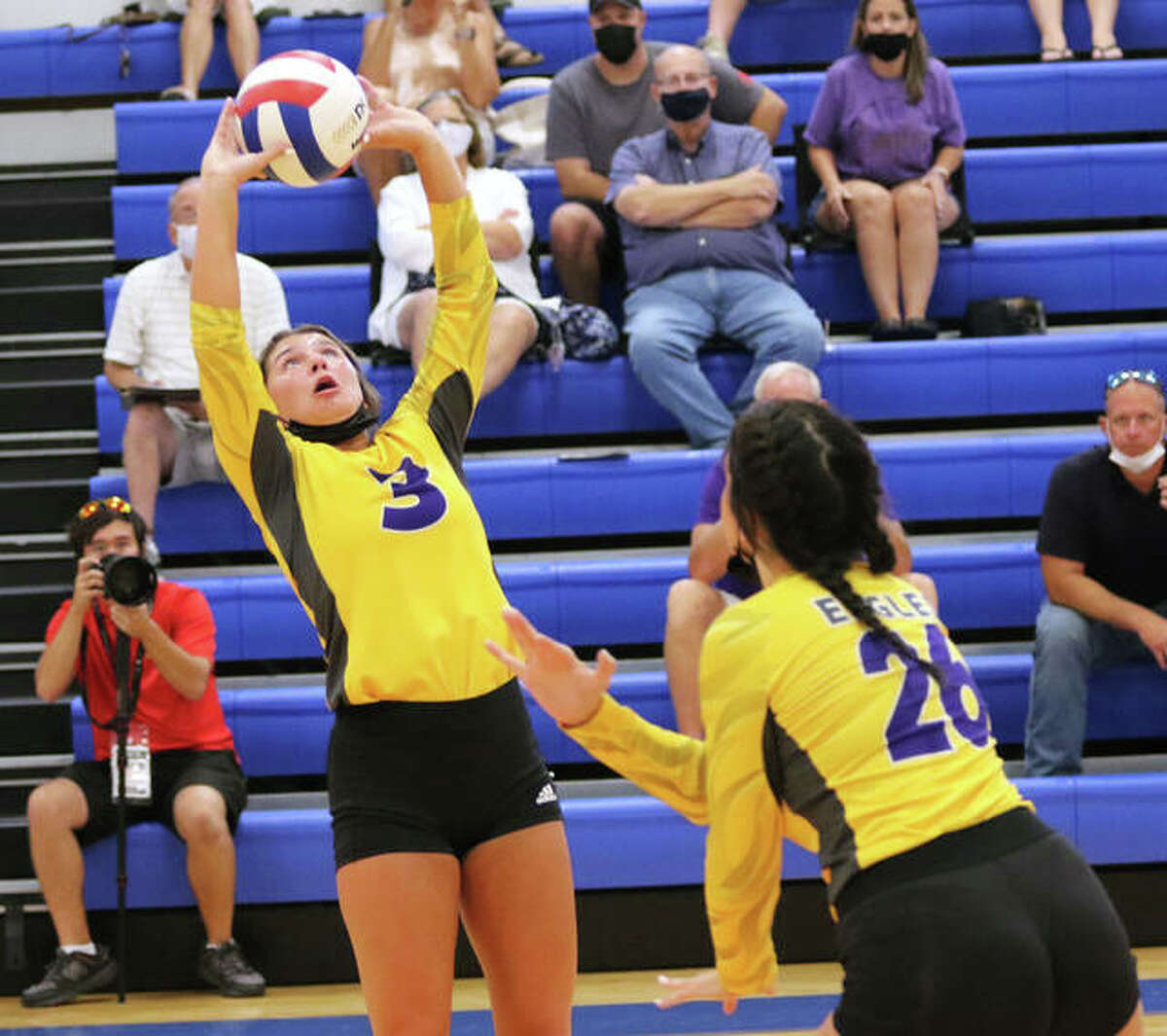 CM’s Maddie Brueckner (3) sets as teammate Camryn Gehrs heads to the net in an August match at the Roxana Tourney. On Thursday, Brueckner had a double-double with 23 assists and 10 digs in the Eagles’ three-set MVC loss at Highland.