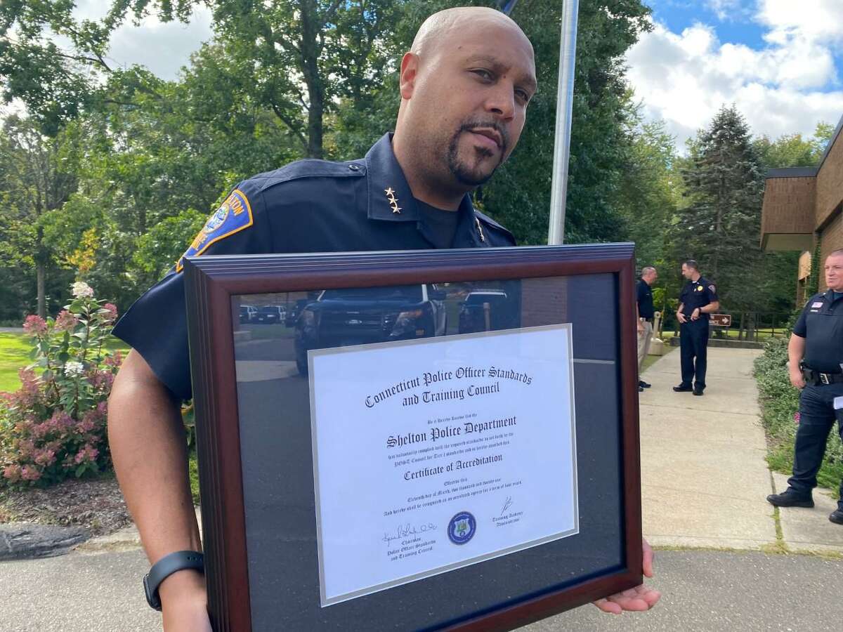 Shelton Police Chief Shawn Sequeira shows of the plaque recognizing the force has earned state Tier 1 reaccreditation.