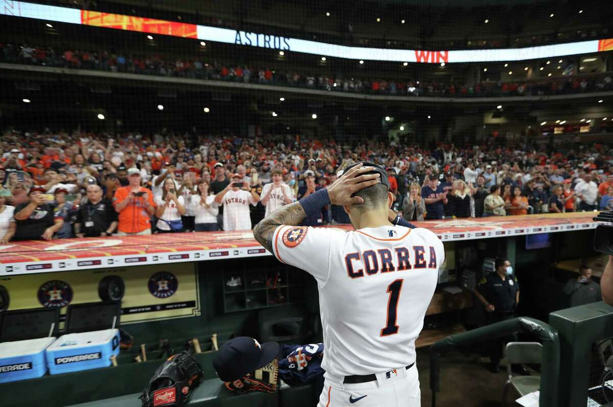Houston Astros shortstop Carlos Correa (1) takes off his jersey as the crowd cheered after Houston clinched the AL West with their 3-2 win over Tampa Bay Rays after an MLB baseball game at Minute Maid Park, Thursday, September 30, 2021, in Houston.