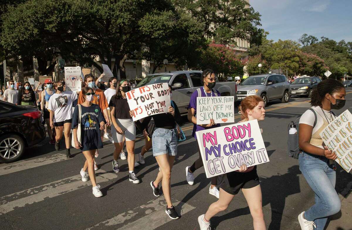 University of Texas students march from the UT campus to the Capitol on Tuesday September 7, 2021, to protest the law banning abortions after six weeks. More than 100 students marched to the Capitol while chanting and carrying signs to voice their opposition to the law that went into effect last week. (Jay Janner/Austin American-Statesman/TNS)