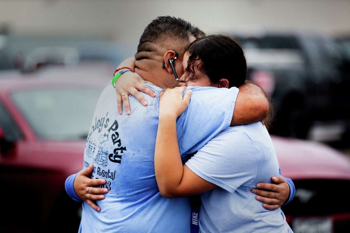 Yes Prep Southwest Secondary school student Kimberly Mendez, 14, embraces her father Rudis Méndez, 41, at a parking lot on the corner of Hiram Clarke Rd. and W. Fuqua St. after a shooting took place at her school, Friday, Oct. 1, 2021, in Houston. 