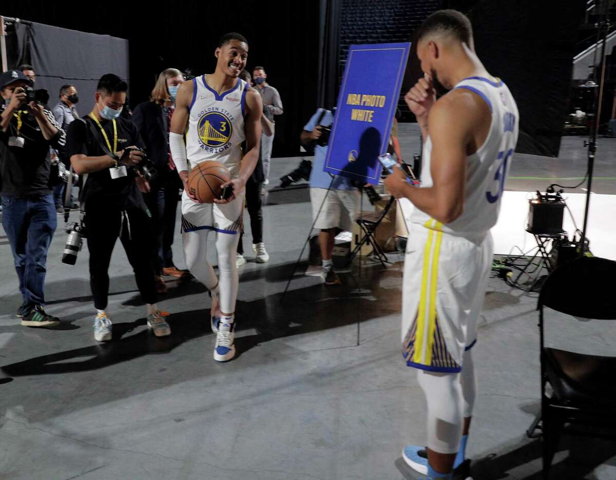 Jordan Poole goofs around with Stephen Curry after he had his portrait made as the Golden State Warriors held their media day for the 2021-22 season at Chase Center in San Francisco, Calif., on Monday, September 27, 2021.