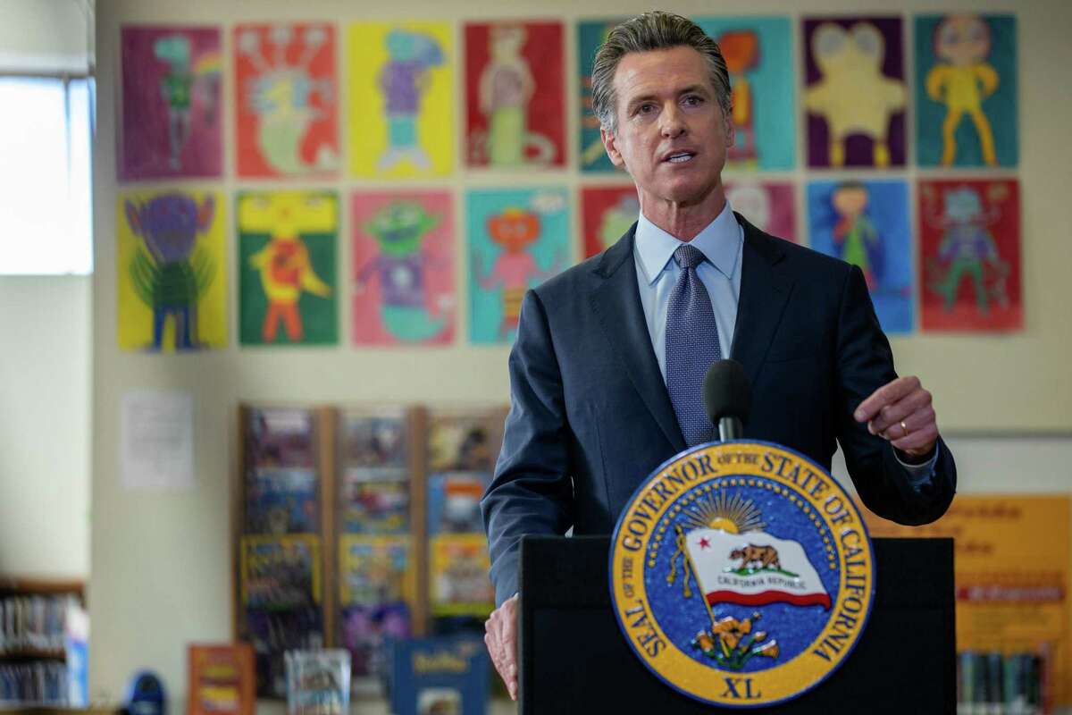 California Gov. Gavin Newsom speaks with students at James Denman Middle School in San Francisco before a press conference announcing a new statewide school vaccine mandate.