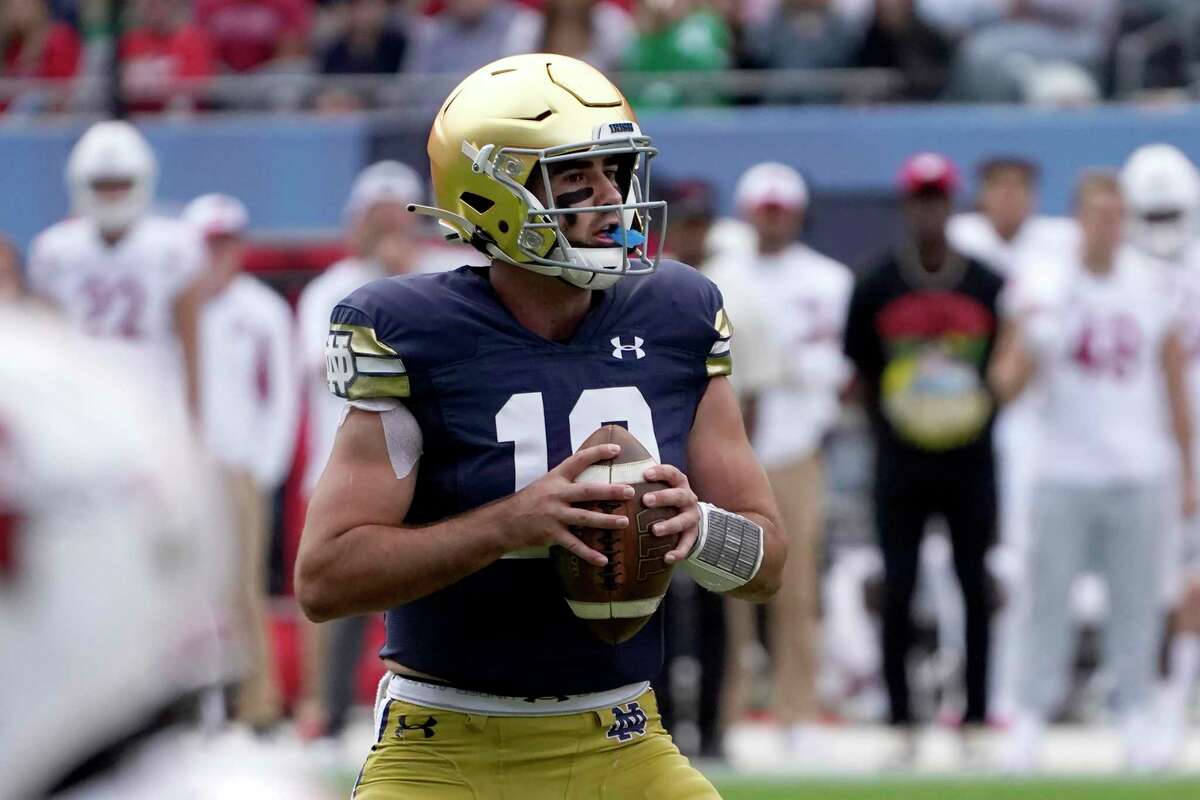 Notre Dame quarterback Drew Pyne looks downfield before showing a touchdown pass to wide receiver Kevin Austin Jr., during the second half of an NCAA college football game Saturday, Sept. 25, 2021, in Chicago. Notre Dame won 41-13. (AP Photo/Charles Rex Arbogast)